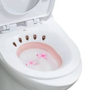 Bidet Portable Rose et Pliable sur un toilette sur fond blanc